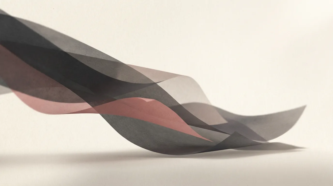 Overlapping translucent paper layers in soft grey and muted rose curving above a pale cream surface, suggesting words moving from one place to another